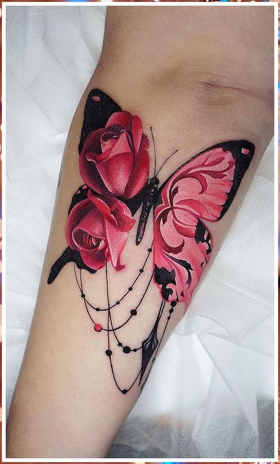 Watercolor pink butterfly tattoo on the shoulder